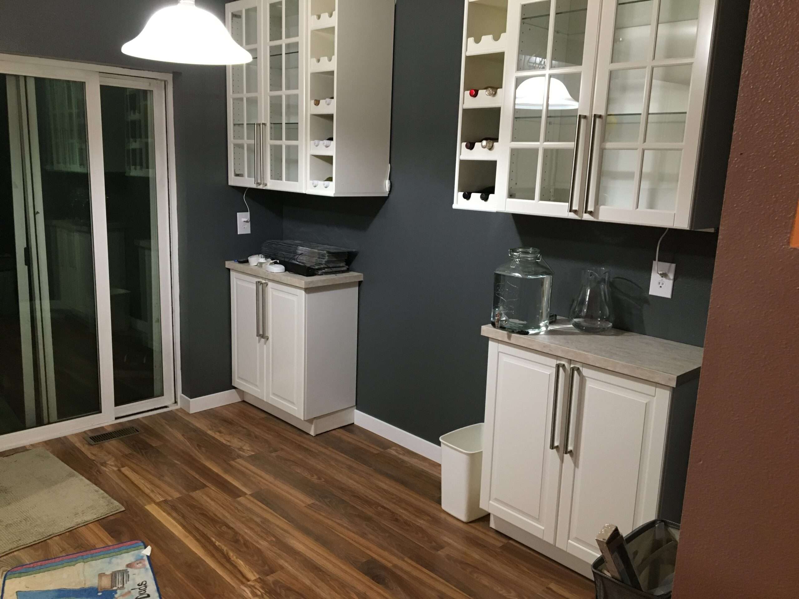 Modern kitchen with white cabinets and wooden flooring