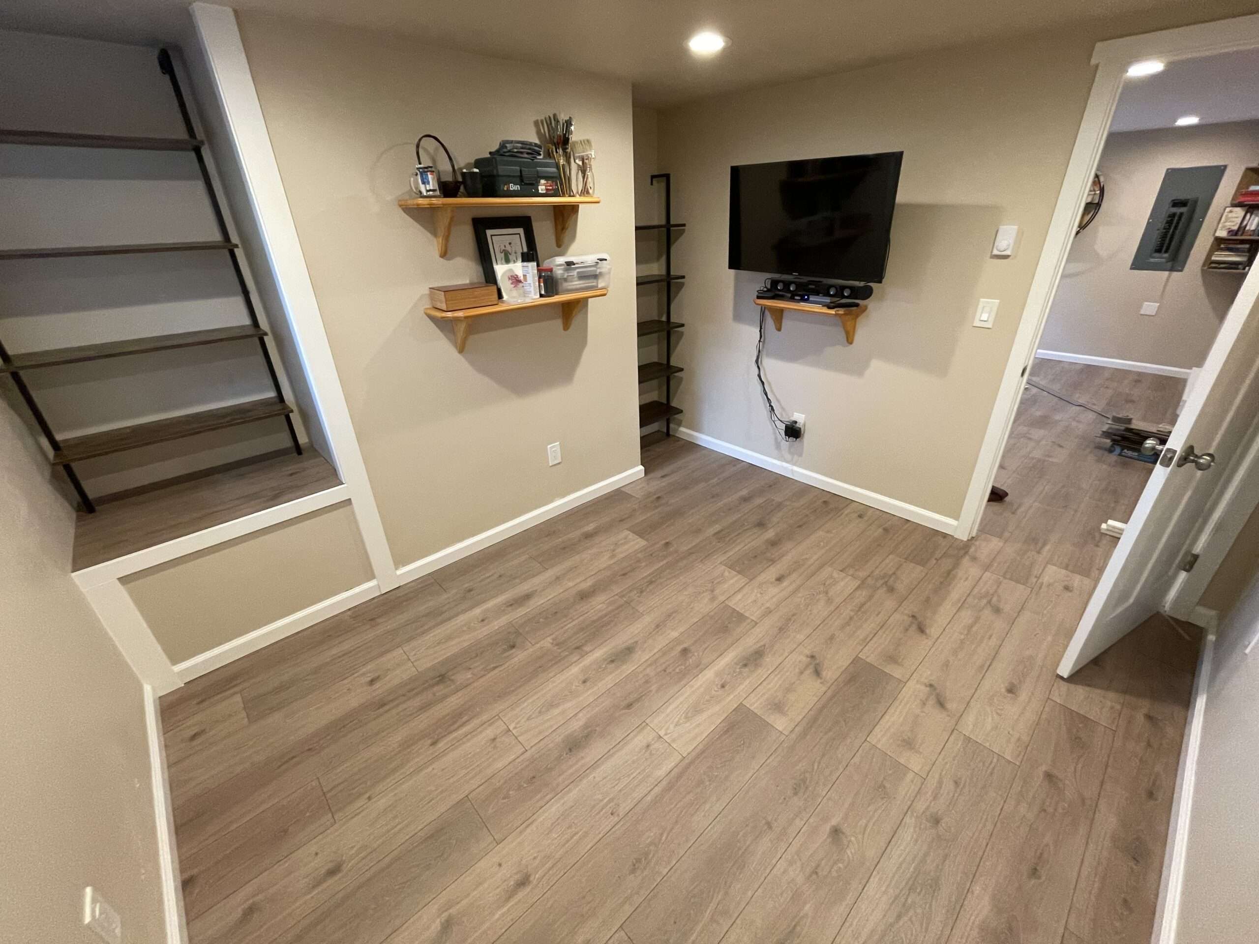 Modern room with wall-mounted TV and wooden shelves